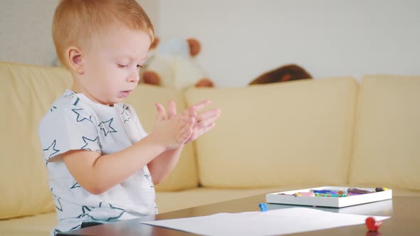 Kid Boy Playing with Plasticine at Home, Creative Kid with Play Clay Molding at the Table