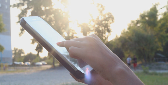 Girl at Sunset Using Touchpad alt