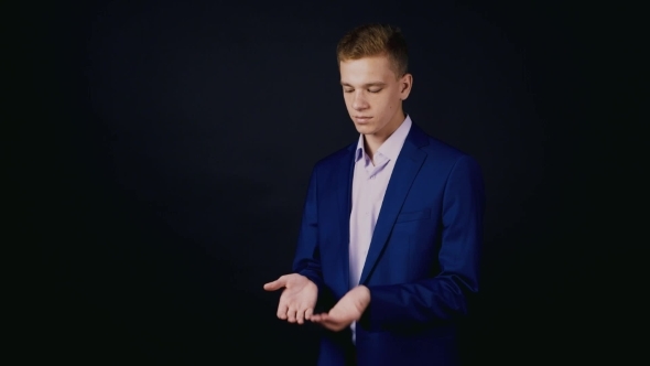 Young Magician Show a Trick With a Coin