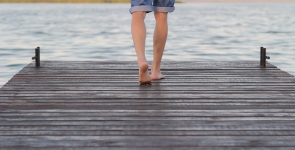 The Young Man Goes Barefoot On The Bridge