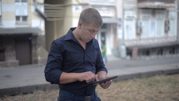 Typing on Digital Tablet on Street