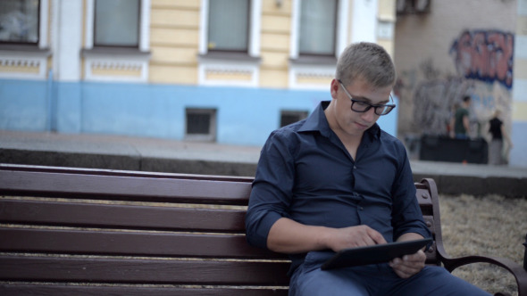 Using Tablet, while Sitting on Bench