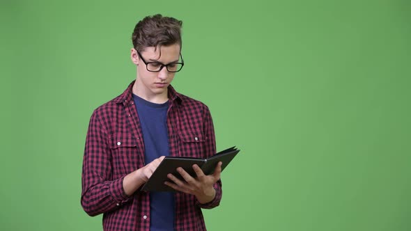 Young Handsome Teenage Nerd Boy Studying