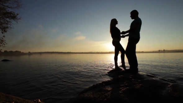 Silhouette Of Couples At Sunset alt