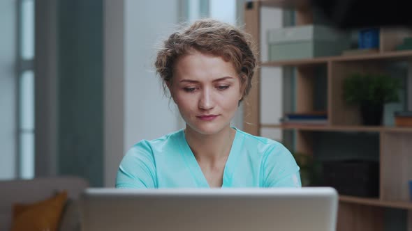 Female Medical Doctor Working at Desk in Medical Office on Laptop Close Up