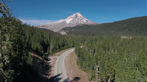 Aerial of cars traveling on scenic road next to breathtaking Mt. Hood in Oregon.