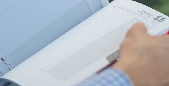 Man Writes In Notebook alt