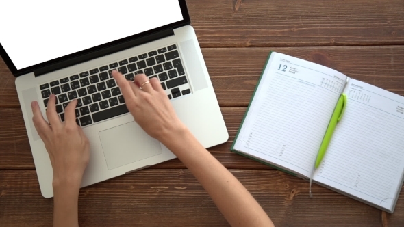 Working On Laptop On Wooden Desk