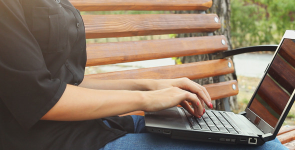 Girl Using a Laptop in the Park alt