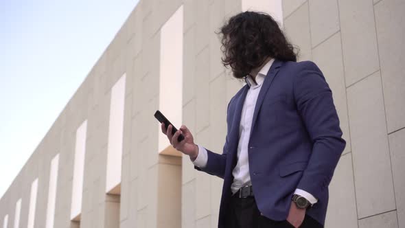 Young Successful Businessman with a Smartphone