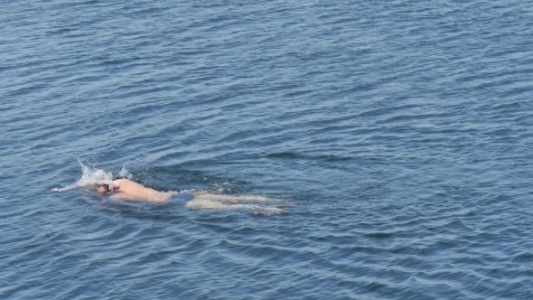 Swimmer in Glasses Man is Swimming in The Lake