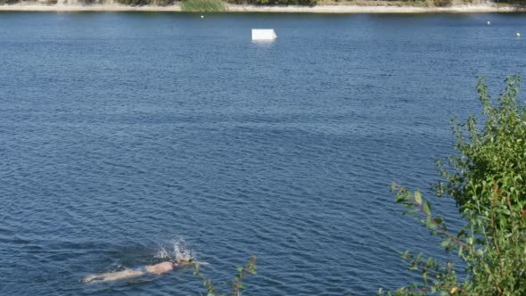 Swimmer Man is Swimming in The Lake River Pond