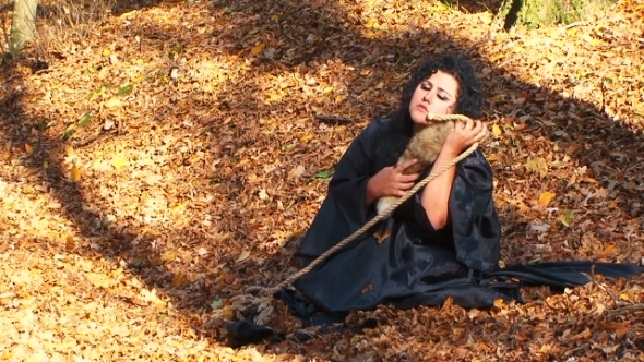 Woman In Black Cuddling A Furtail Sitting In