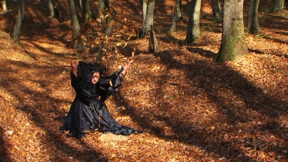 Woman In Black Playing With Leaves In Autumn