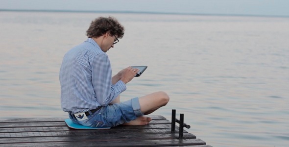 Man Typing On The Tablet