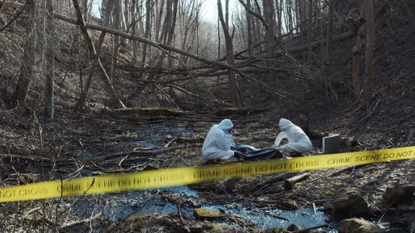 Forensic specialists working in the forest. Crime scene and police concept.