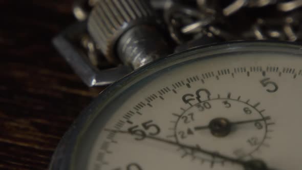 Stopwatch on a Dark Wooden Tabl