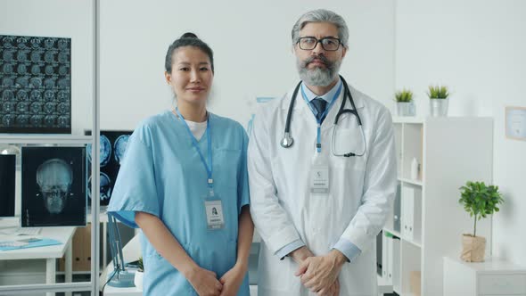 Slow Motion Portrait of Hospital Staff Man and Woman Standing in Modern Office