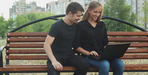 Man and Woman Using a Laptop alt
