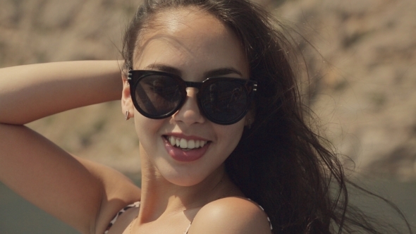 Smiling Girl With Long Hair In Sunglasses