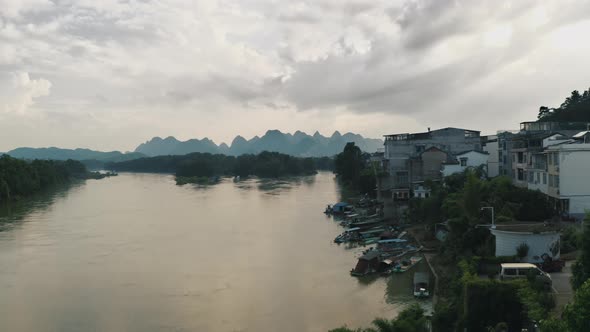 Flooded River on Overcast Day in China, Karst Mountains in Background