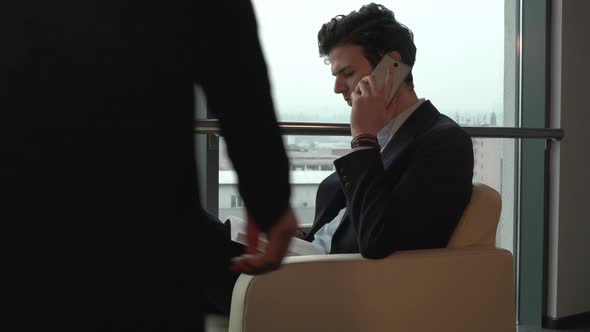 Businessman sitting and talking on the phone