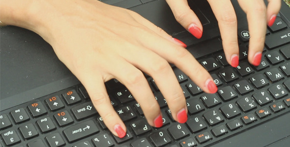 Girl on a Green Lawn Using Keyboard on Laptop alt