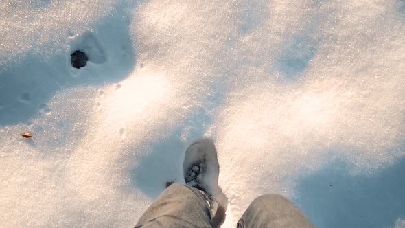 Man's Legs are Walking in the Snow