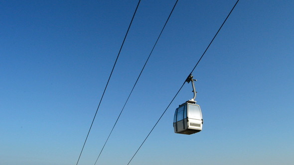 Cable Car Running with City and Sea at Background