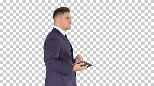 Elegant Young Businessman Using His Pc Tablet While Walking