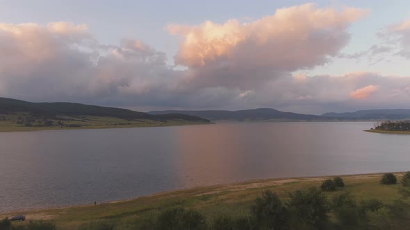 High Flight Over Fresh Cold Mountain Dam in Peaceful Summer Evening at The Magnificent Mountains