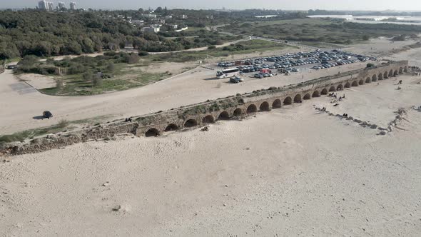 Ancient Aqueduct on the Beach in the City of Caesarea Israel Drone Shot