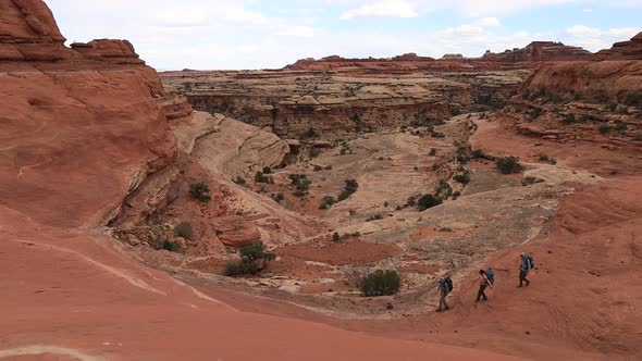 Three Backpackers Descend Into Canyon - Maze District - Canyonlands National Park - Utah