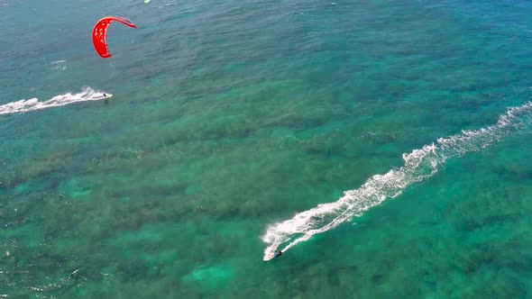 Aerial view of a man kitesurfing in Hawaii.