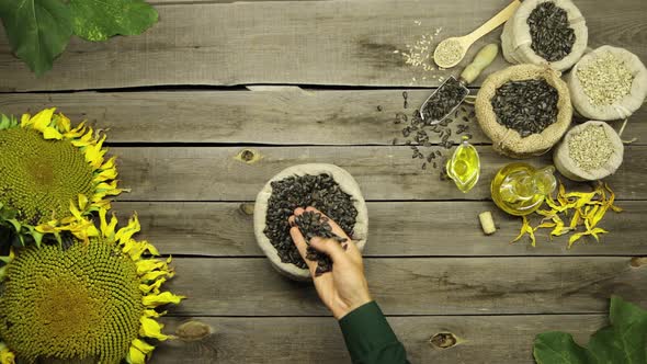 Sunflower Oil and Seeds on an Old Wooden Table. Flat Lay.