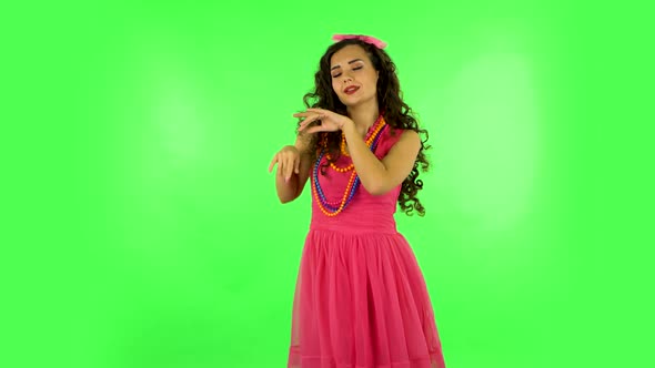 Girl Is Dancing Funny on Green Screen at Studio.