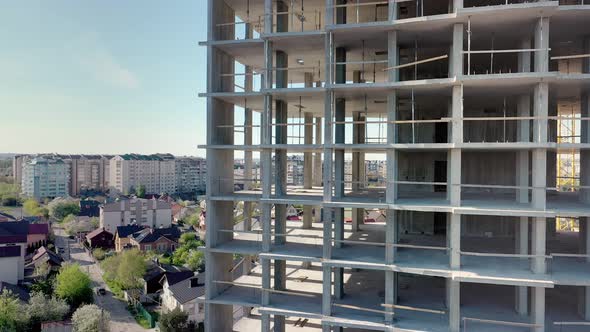 Aerial view of high residential apartment building under construction. Real estate development.