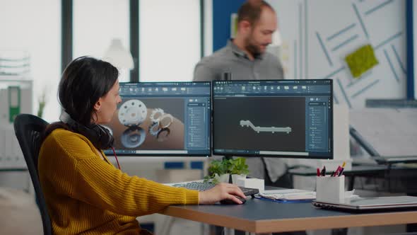 Industrial Designer Holding Tablet Discussing with Woman Engineer