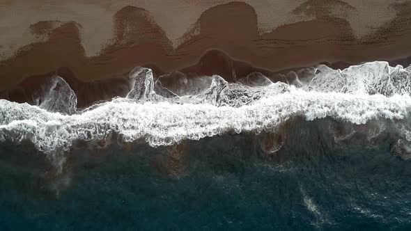 Waves Lapping Against a Secluded Beach from a Bird's Eye View
