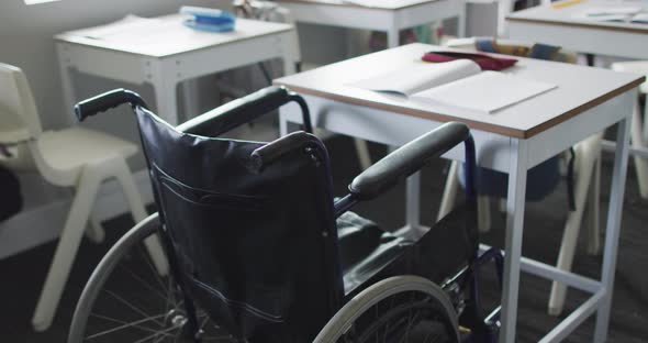 Video of empty wheelchair standing at desk in classroom