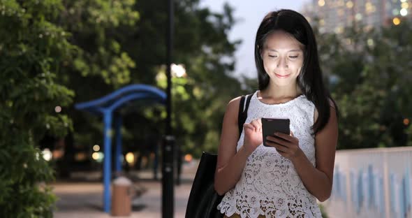 Woman use of smart phone at night 