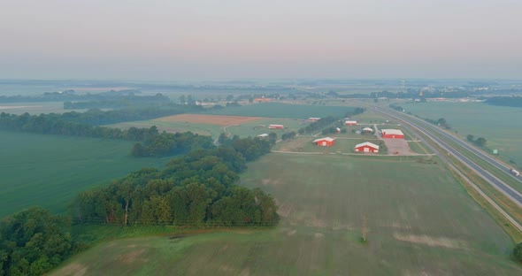 Panorama Landscape View in Sunrise Over the Meadow Across High Speed Highway in the Morning Fog in