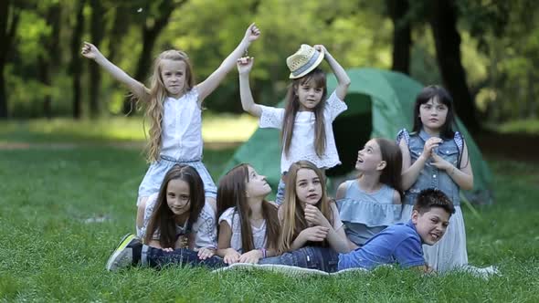 Children in the camp by the bonfire. Group teen outdoors at summer