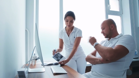 Two Dentists Having a Professional Discussion alt