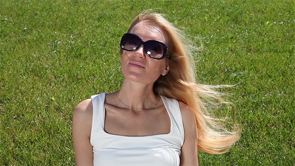 Portrait Of a Young Woman On a Green Lawn alt
