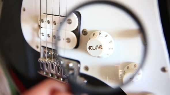 Inspecting Electric Guitar Details Over Magnifying