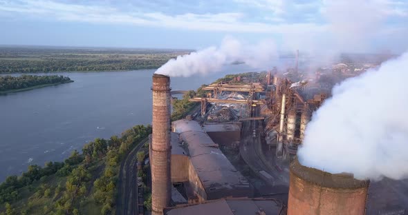 Aerial View of Industrial Zone with a Large Pipe Thick White Smoke