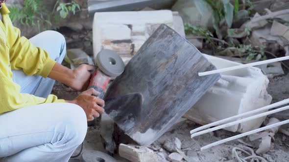 Carpenter polishes old wooden piece with grinder, furniture renovation close up