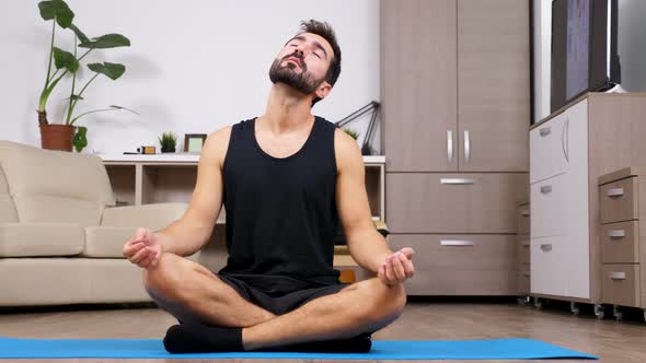 Young Fit Man in Lotus Pose in His Appartment on the Floor