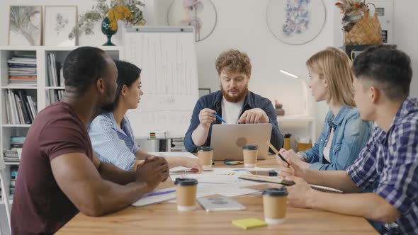 Happy Creative Startups Clap During Corporate Brainstorming Session in Modern Office